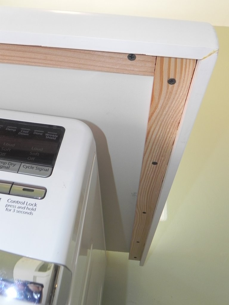 The furring board strip is fastened to the front edges of the countertop from underneath. This provides strength, and also a way to fasten the front moulding.